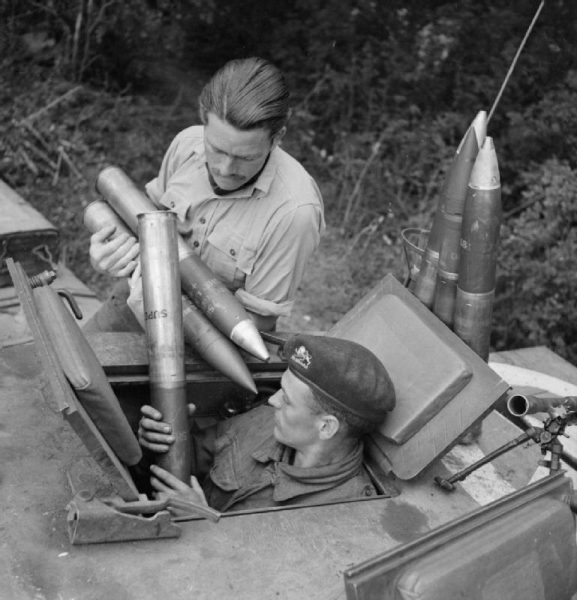 Loading ammunition into a Churchill tank, Normandy July 1944