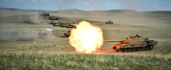 A row of Challenger 2s on a firing range at BATUS, Canada