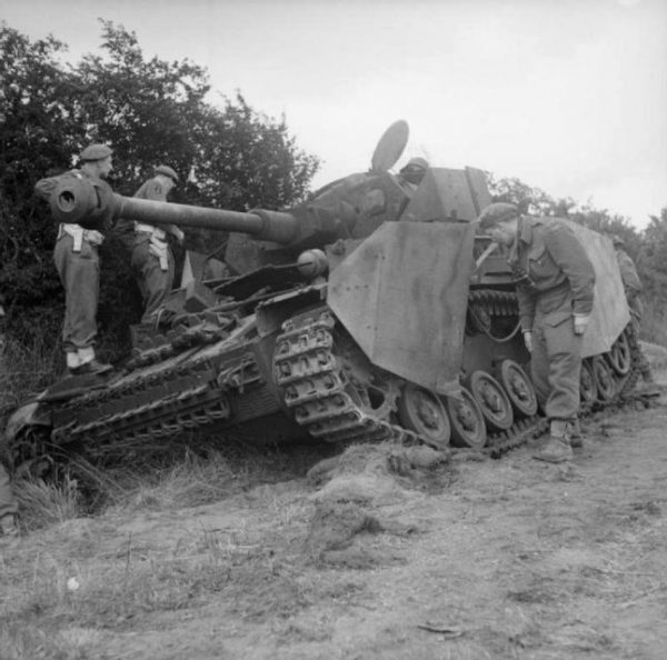 Officers inspect a German Mk IV tank knocked out by the Durham Light Infantry, 11 June 1944.