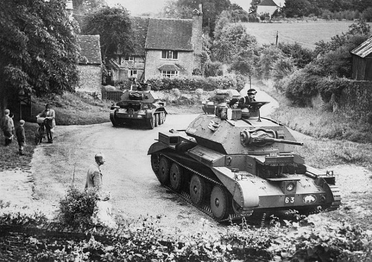 Cruiser Mk IV tanks of 5th Royal Tank Regiment, 3rd Armoured Brigade, 1st Armoured Division, drive through a Surrey village, July 1940.