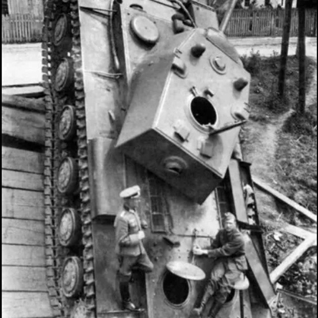Officers investigate a KV-1 that was on a bridge when it collapsed