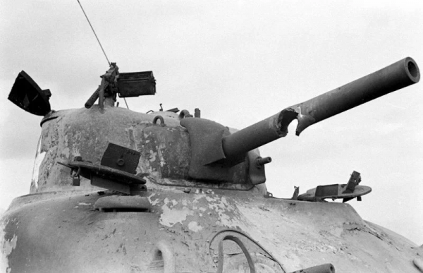 Shot through the barrel of a M4A1 Sherman tank burnt out in a field in Italy.