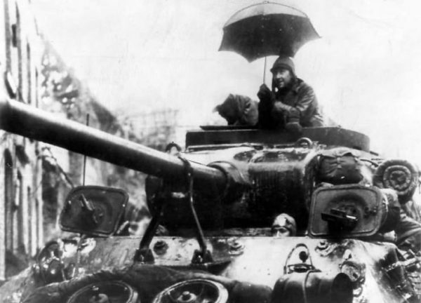 9th Army soldier under umbrella atop M36 Jackson – Germany 1945