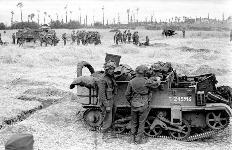 A Universal Carrier in an oat field in front of the ruins of Saint Contest.Photo PhotosNormandie CC BY-SA 2.0