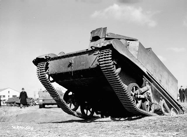 Army vehicle (Universal Carrier) being driven up a slope.Photo BiblioArchives LibraryArchives CC BY 2.0