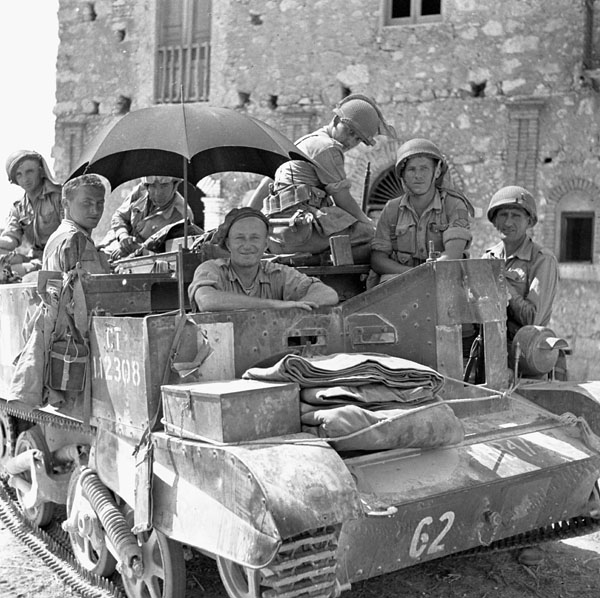 Infantrymen of the Edmonton Regiment in a Universal Carrier, using an umbrella to provide some shade. Photo BiblioArchives LibraryArchives CC BY 2.0