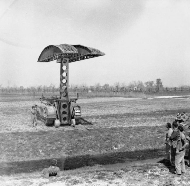 A Churchill bridgelayer of 51st Royal Tank Regiment in action during a demonstration in the Mezzano area, 30 March 1945.