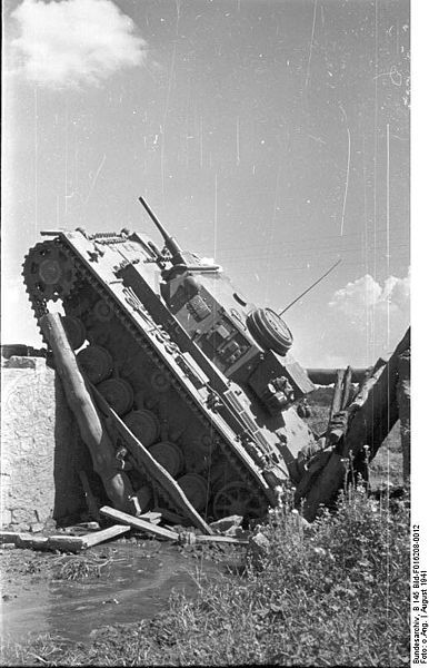 This Panzer III lays where it fell, after the wooden bridge it was crossing collapsed near Dnieper, Soviet Union, August 1941.