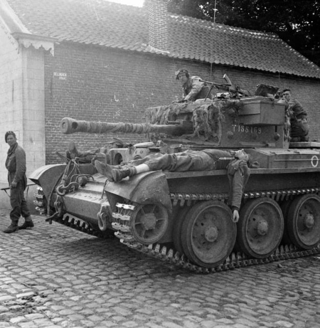 Wounded German soldiers being ferried to an aid post on the hull of a Cromwell tank